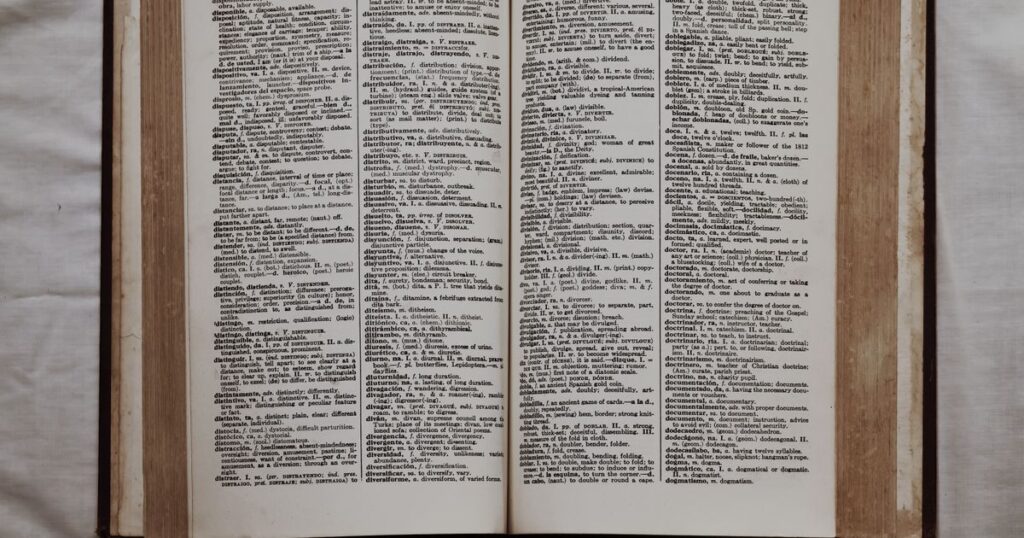 An open bilingual dictionary lying flat, showing two columns of entries in different languages