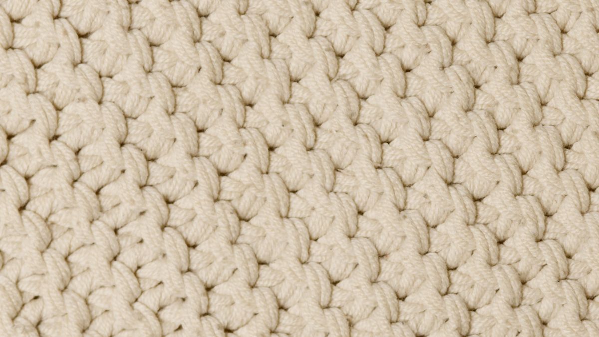 Close-up of a cream coloured knitted fabric
