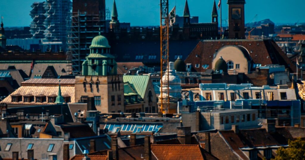 Copenhagen rooftops and church towers seen across the city under an open sky