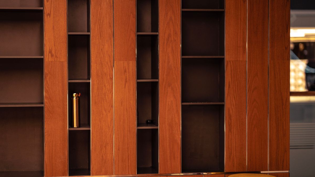 Warm wooden shelves with almost nothing standing on them